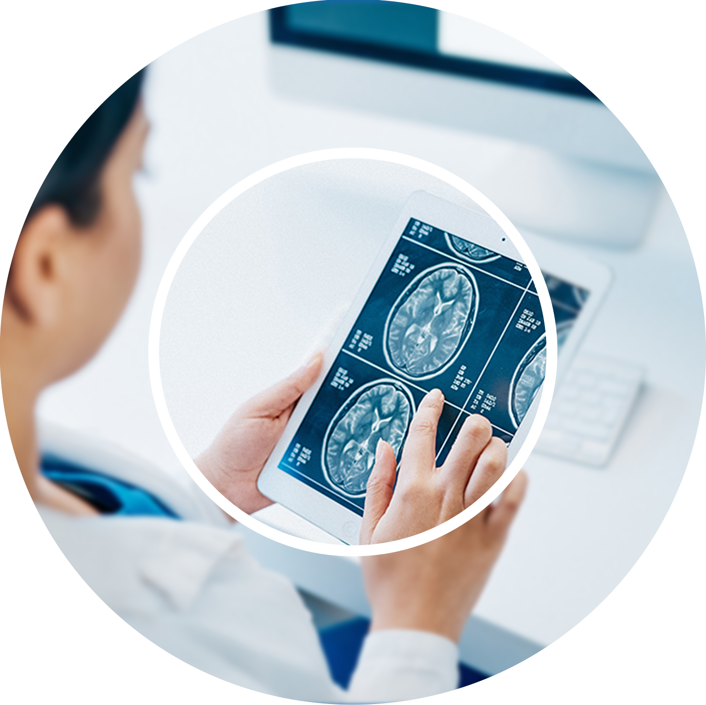 A person examines brain scan images on a tablet, focusing intently. The setting is a clinical environment, conveying a sense of concentration and analysis.